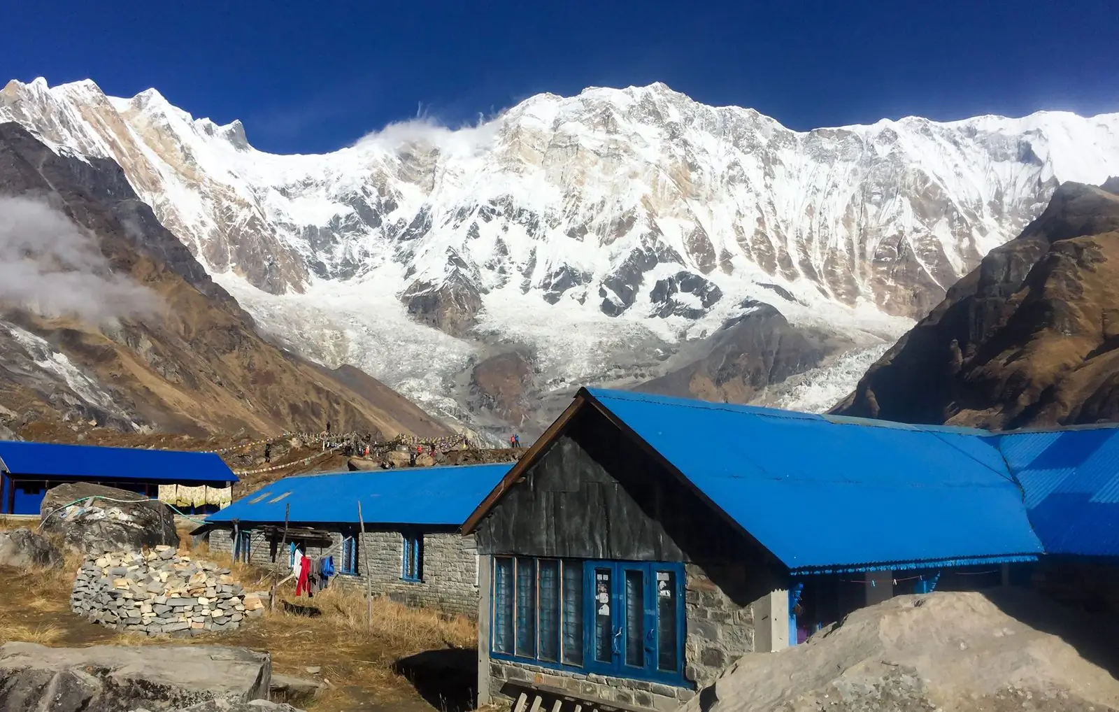 Blue-roofed tea houses below the Annapurna massif