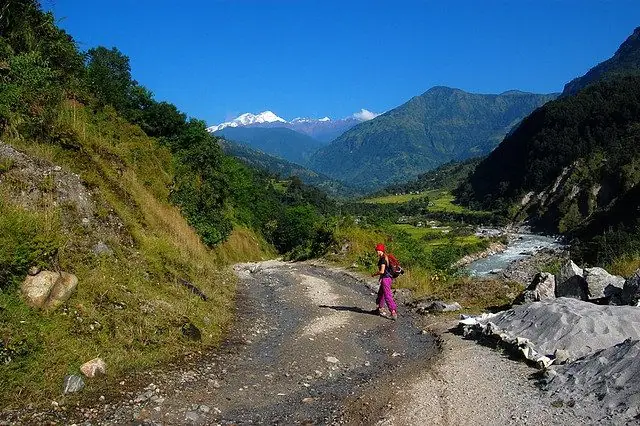 Villager on a gravel track in a green Annapurna valley