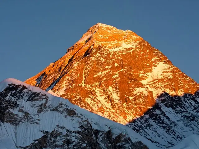 Everest summit pyramid glowing orange in evening light