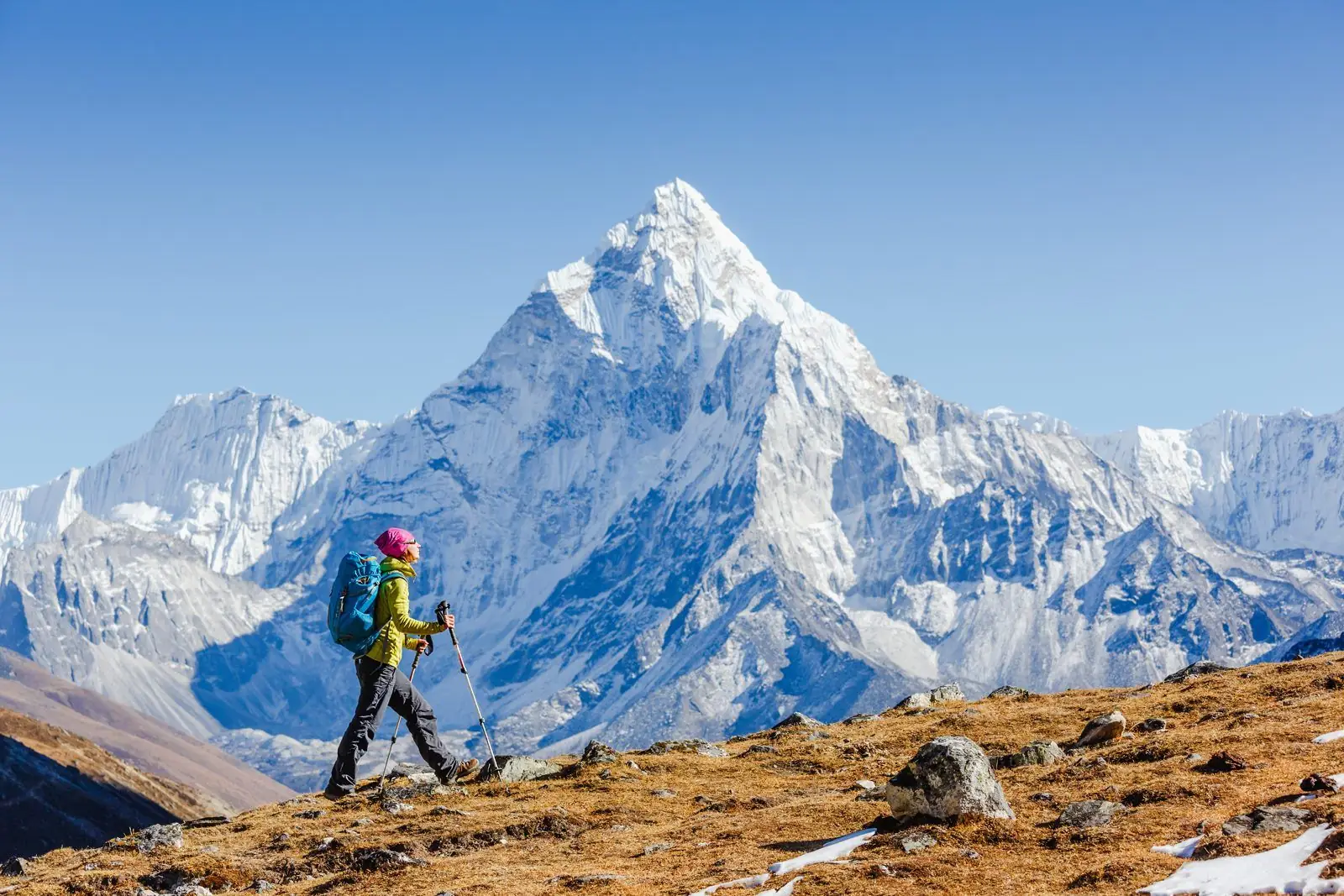 Trekker walking along a ridge with Ama Dablam behind