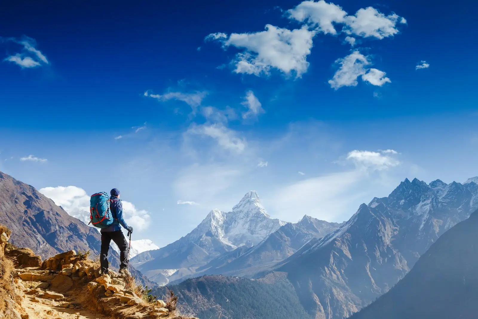 Trekker with a backpack at a viewpoint looking towards Ama Dablam