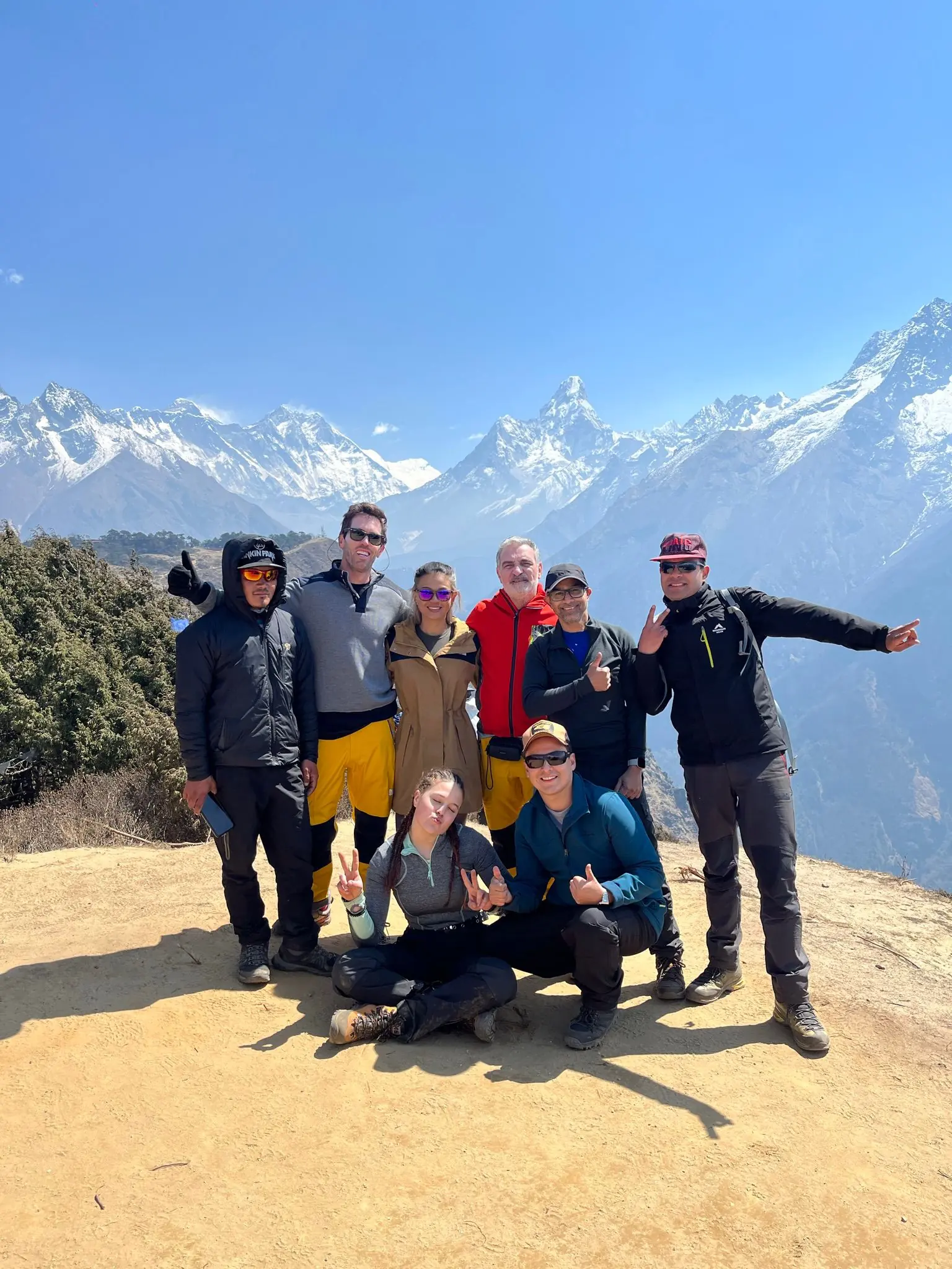 Group of trekkers with Himalayan peaks in the background
