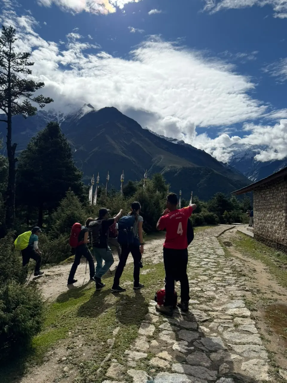 Trekkers pausing on the trail with mountain views ahead