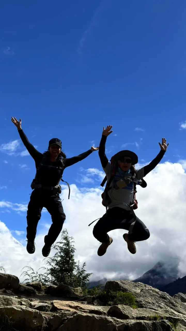 Two trekkers jumping for joy on the trail